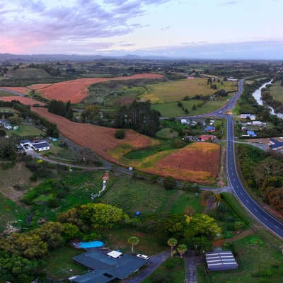 A panoramic view of a sunset over rolling hills and fields.